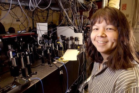 A photo of Deborah Jin with some lab equipment 