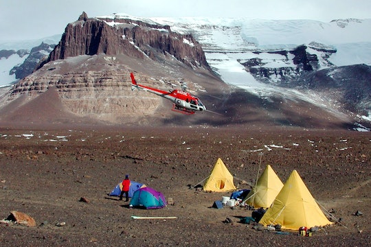 A helicopter prepares to land at Beacon Valley in the Dry Valleys of Antarctica.
