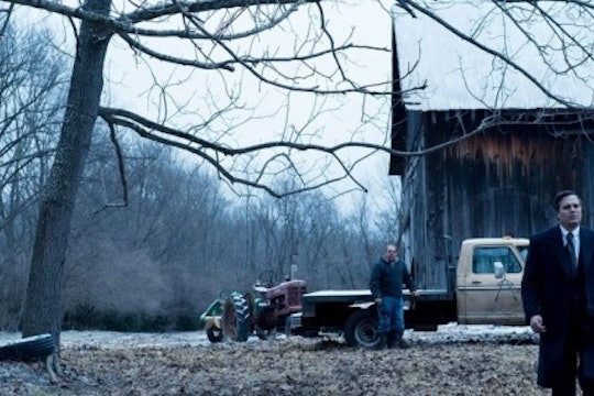 A still from the movie Dark Waters. A man walks in a field against an Appalachian backdrop.