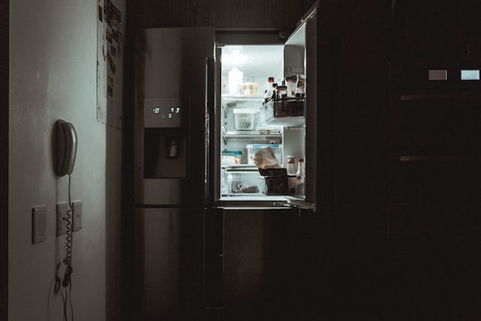 An open fridge or refrigerator in the dark.
