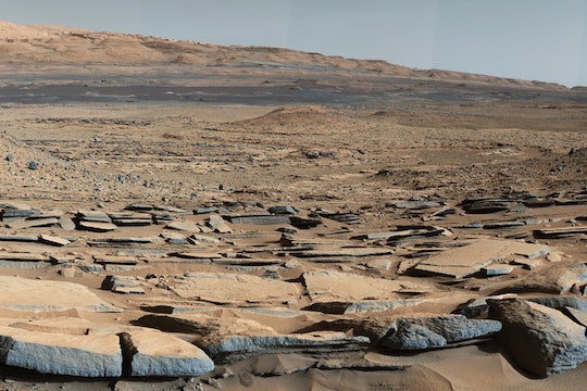 A view from the "Kimberley" formation on Mars taken by NASA's Curiosity rover. The strata in the foreground dip towards the base of Mount Sharp, indicating flow of water toward a basin that existed before the larger bulk of the mountain formed