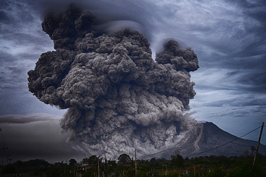 Erupting volcano with huge smoke plume